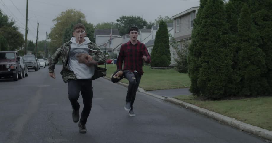 Two teenagers race down the street