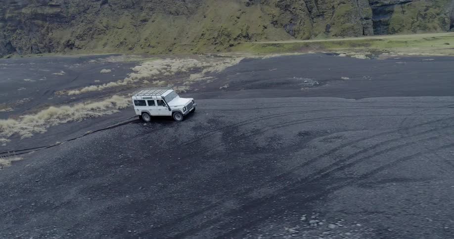 The white vehicle quickly climbs the dirt hill