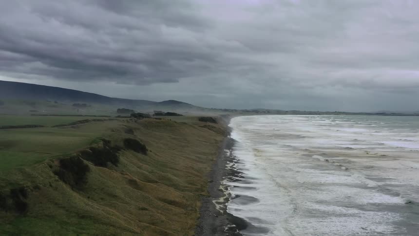 A green valley is next to an ocean