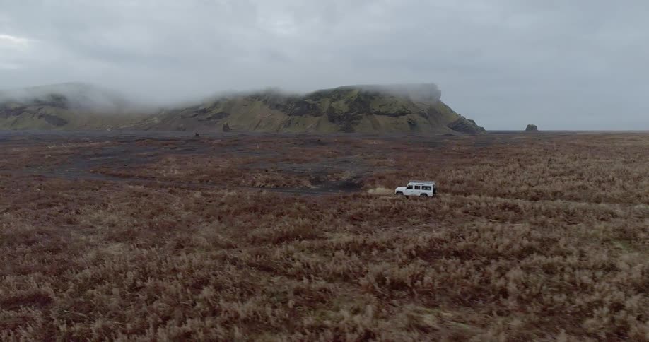 A vehicle drives on a rural road