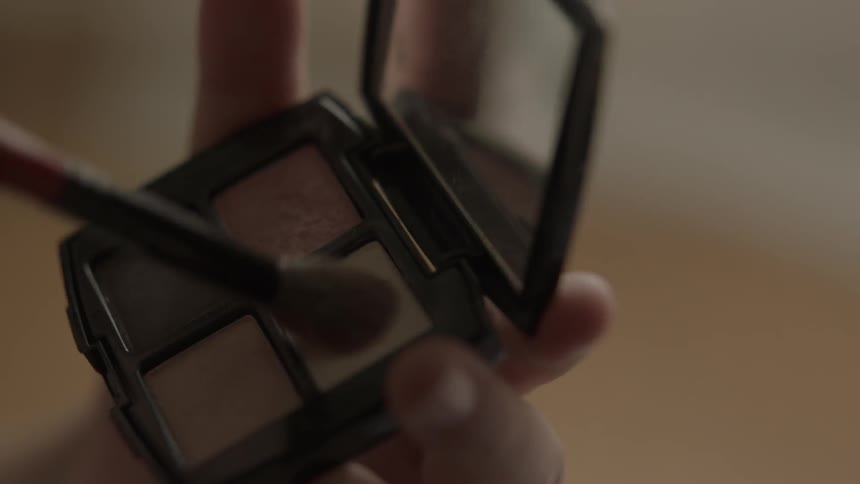 A woman is getting ready to put on makeup