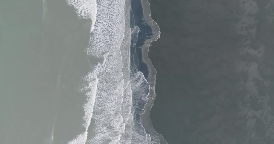 Ocean waves wash ashore a sandy beach