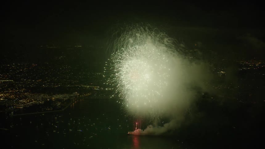 Impressive fireworks display finale over the ocean (Aerial)