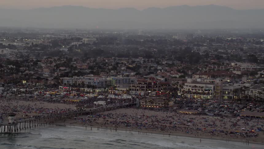 Aerial view of Crowds of People at the Beach with fireworks