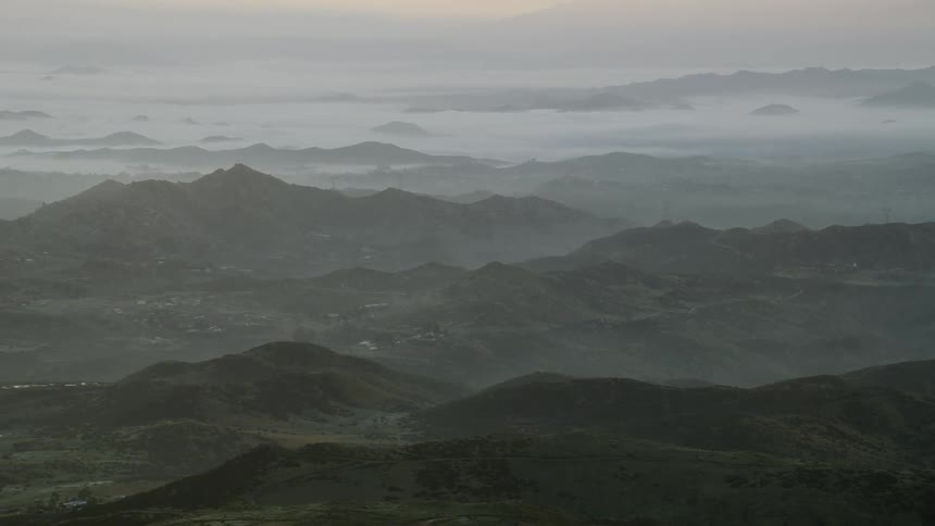 Jagged peaks and hills at twilight