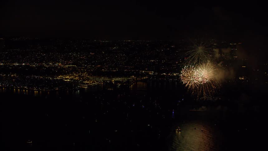 Fireworks are filmed from a helicopter above the ocean on 4th of July