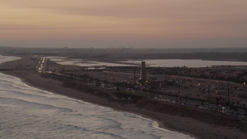 Ocean waves wash ashore a beach at sunset