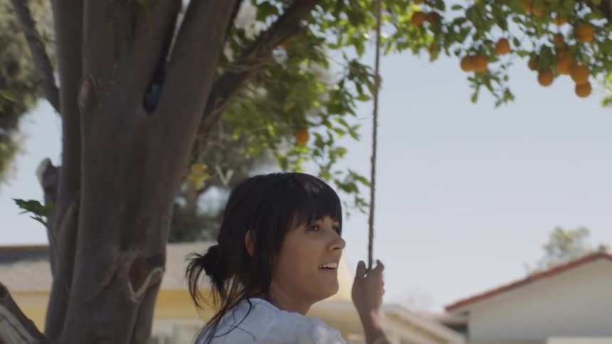 A woman is laughing in her yard