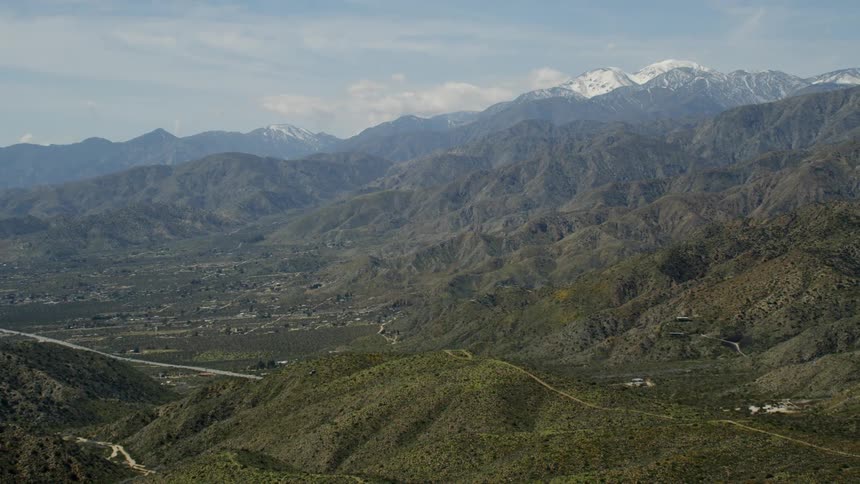 The green mountains have a town at the bottom