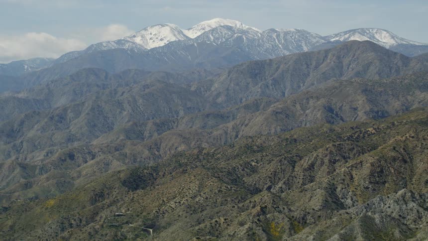 The tall mountains are covered with fog at the top