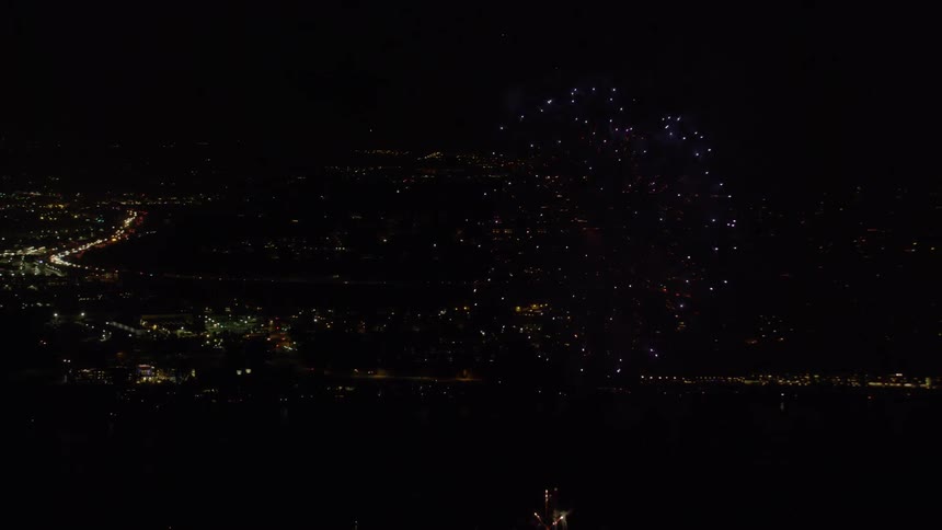 Fireworks explode in the night sky