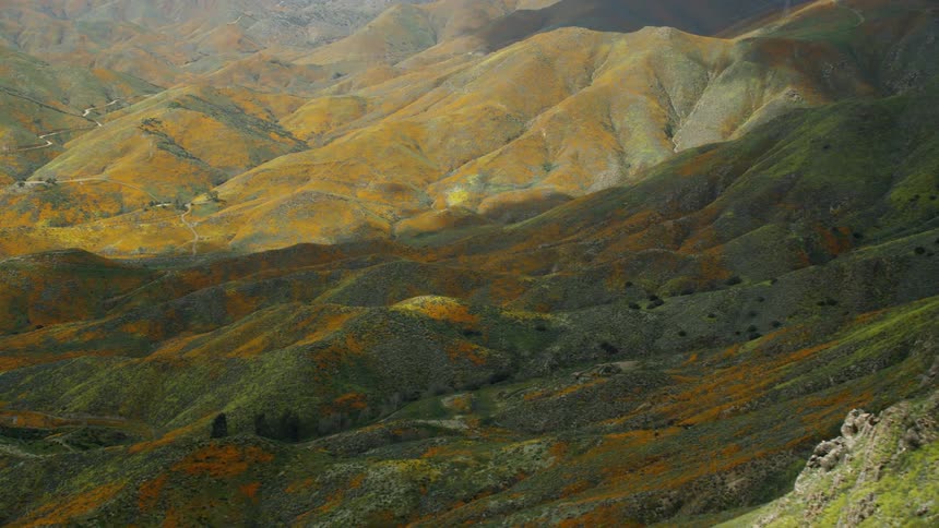 The hills are partially shaded by clouds