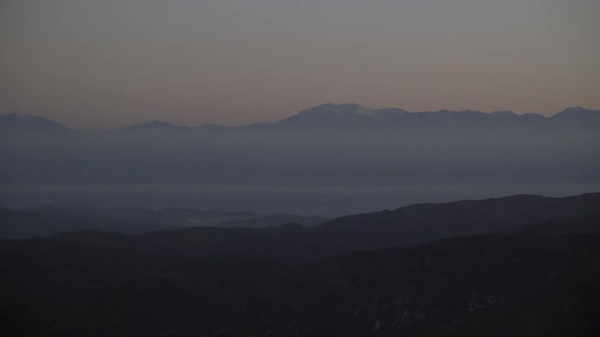 The fog is thick and covering the mountains at dawn