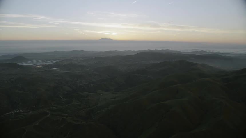 Capturing the moment the sun sets behind a mountain