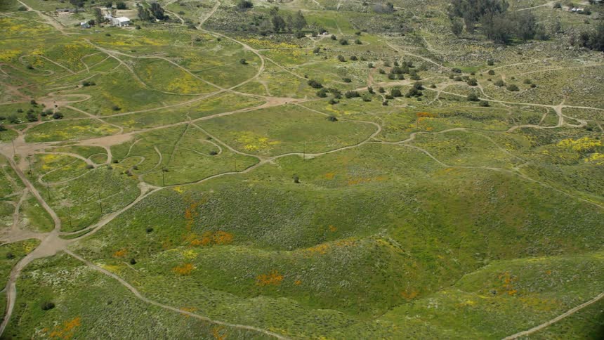 Dirt roads cover a hilly landscape