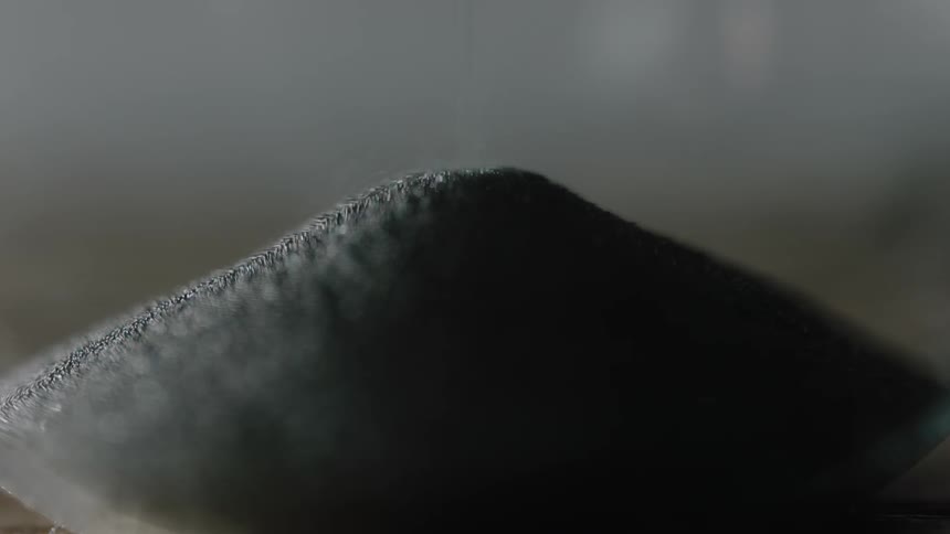 Sand falls into a pile