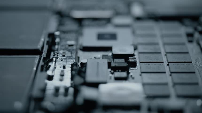 A light shines and then fades on electrical boards and components