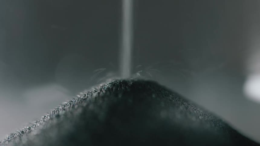 Sand falls in an hourglass