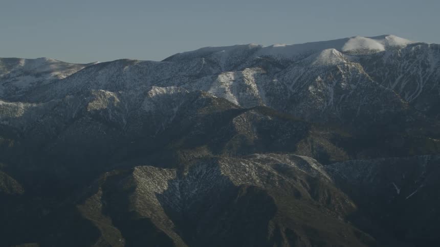 The tall mountains are covered with snow at their peak