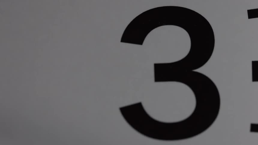 The number three is passed by the clock arm