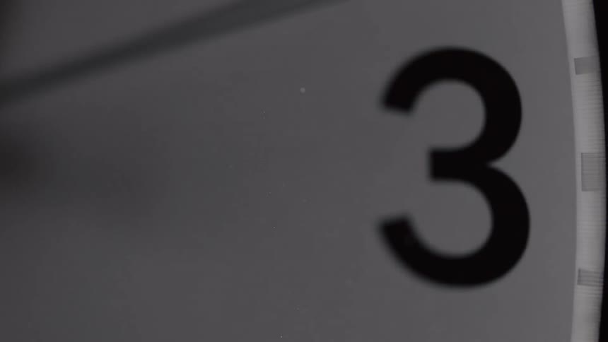 Extreme closeup of a wall clock working