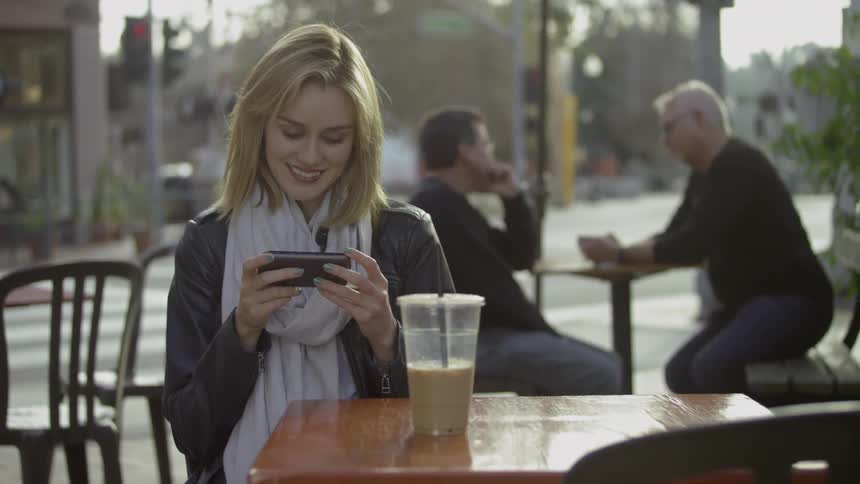 A woman is watching her phone