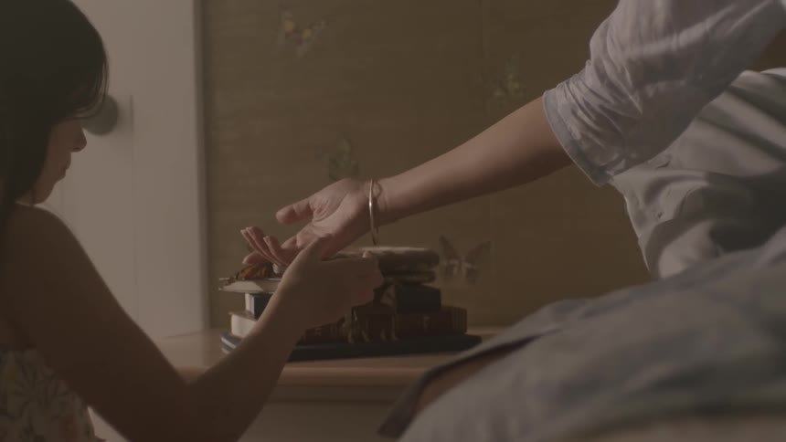 Woman moves someone's hand towards a butterfly