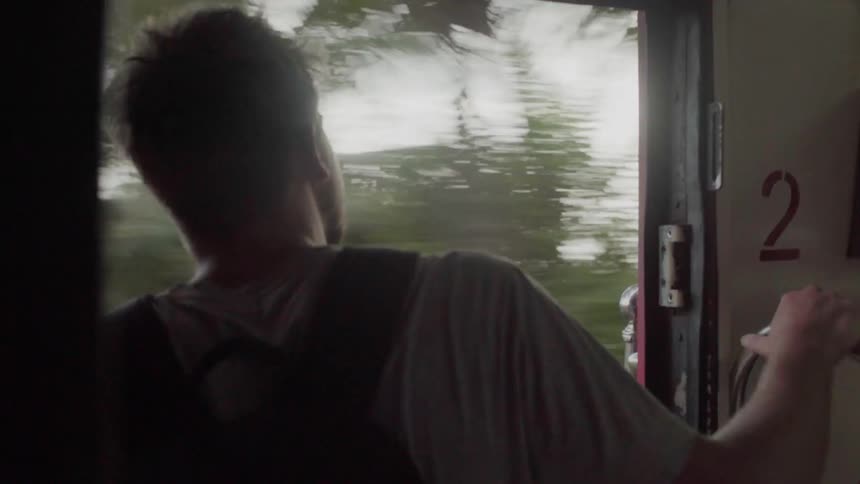 Man riding on a bus looks out the window