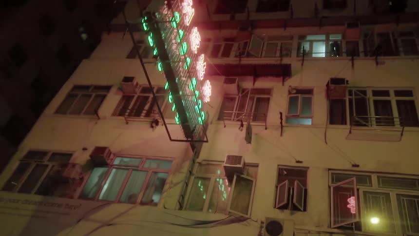 A neon sign lights up the outside of a building