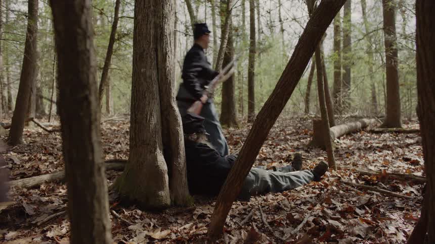Soldiers run through a forest
