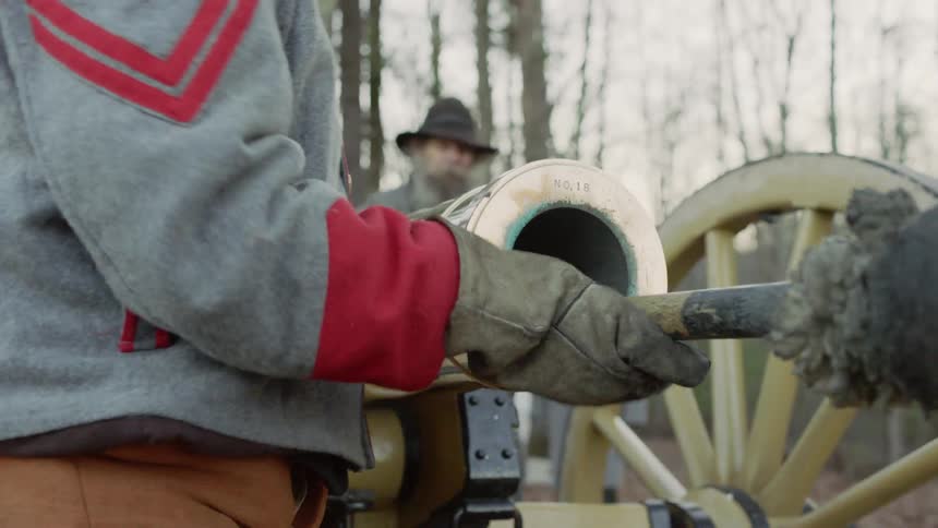 Soldiers load a cannon