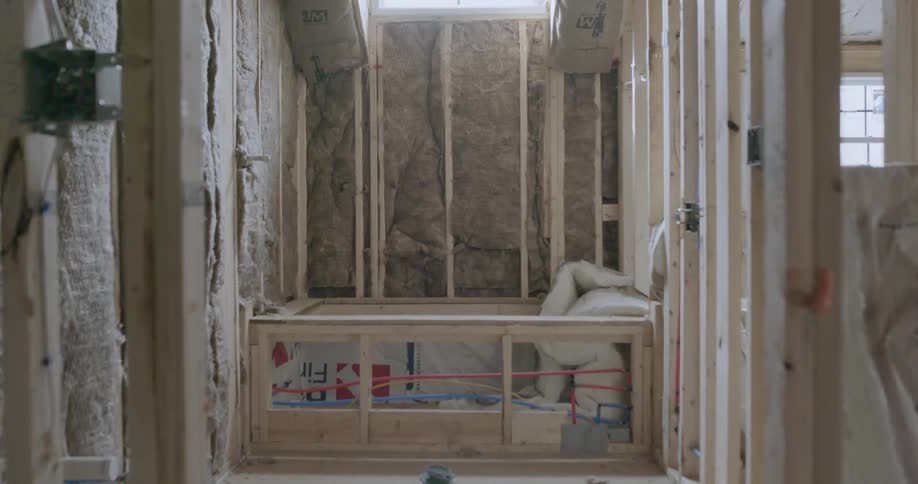 Sunlight shines into an unfinished bathroom