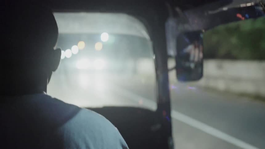 A man drives a taxi car at night