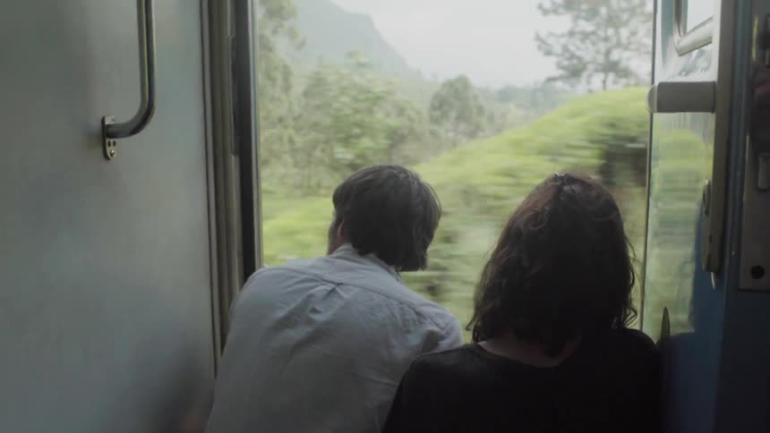 Man and woman ride a train