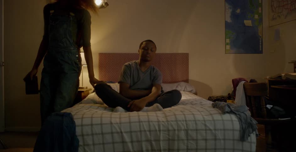 A woman forces a young boy to get out of bed