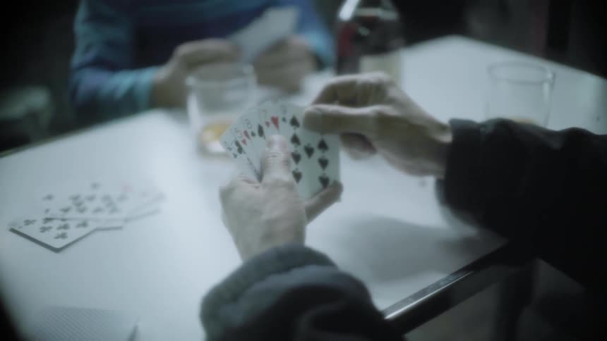 A group of people play cards together