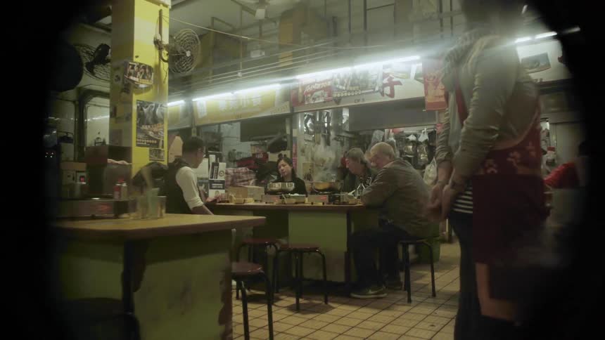 People are served food inside a restaurant