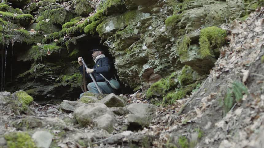 A man on the hill loads his rifle