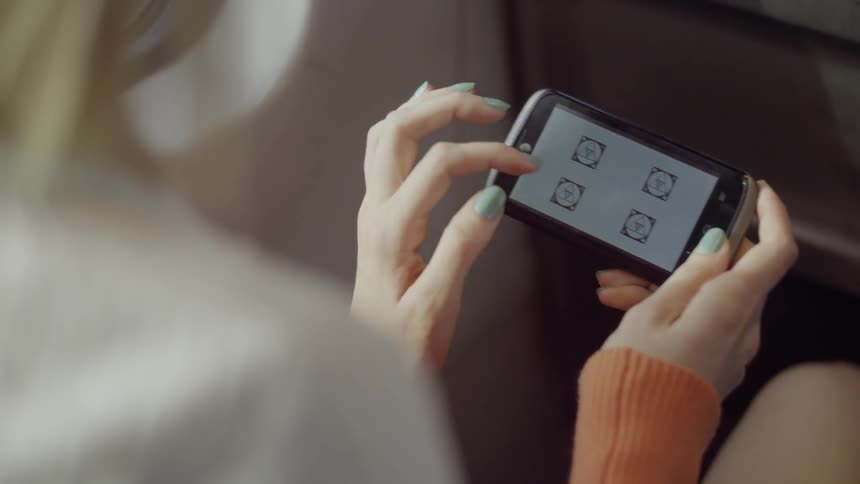 A woman is playing with her phone