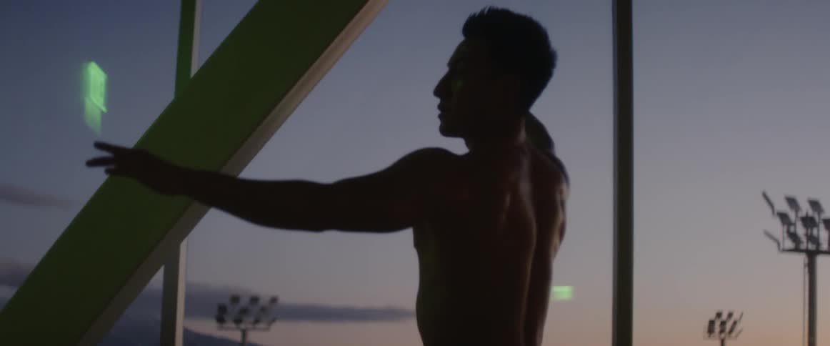 A man doing yoga outdoors at sunset