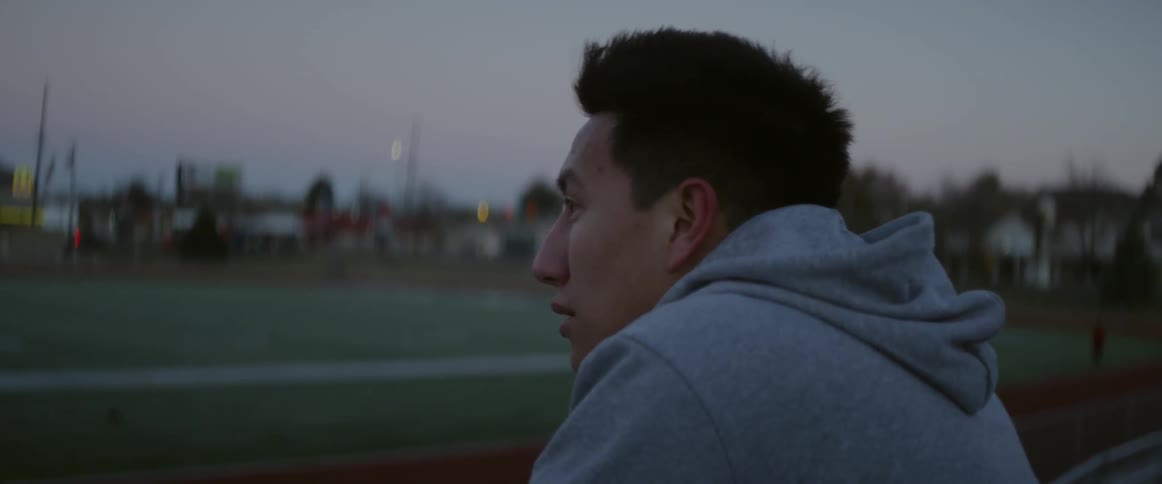 A man sits near the track and catches his breath