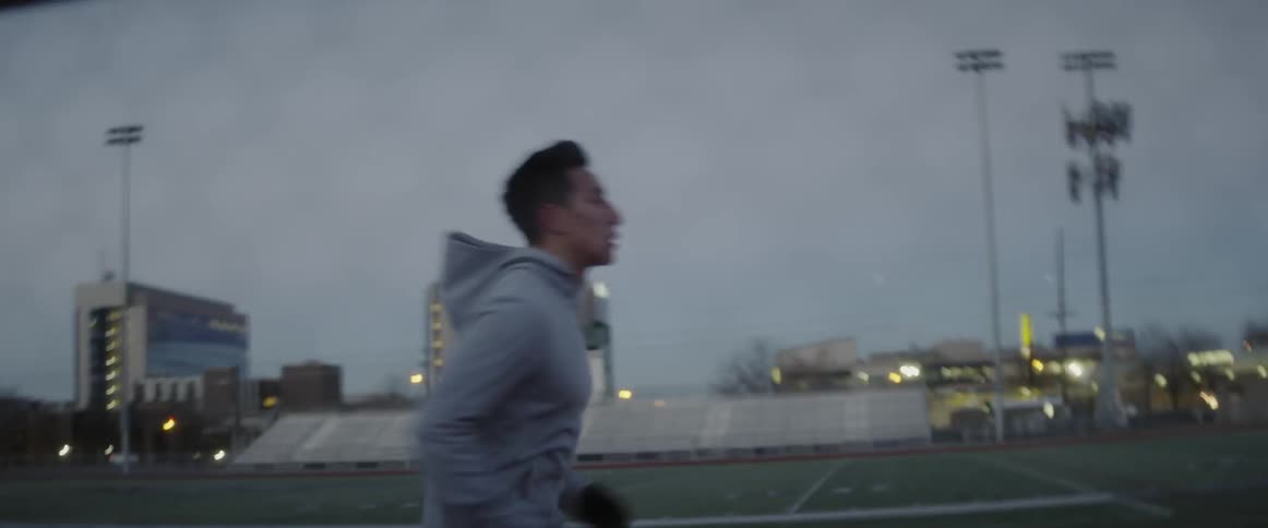 Man runs on an outdoor race track