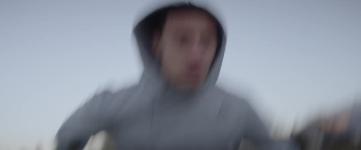 Man runs under a blue sky