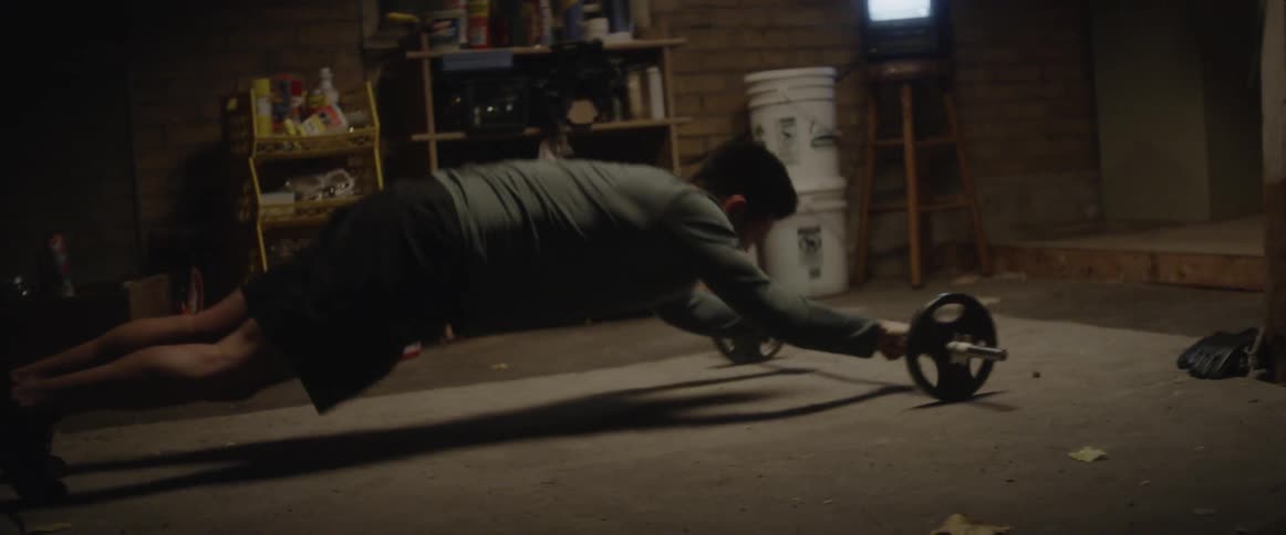 A man works out in a basement