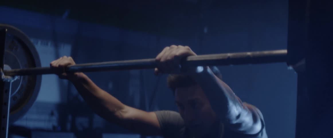 A man rests after exercising in a gym