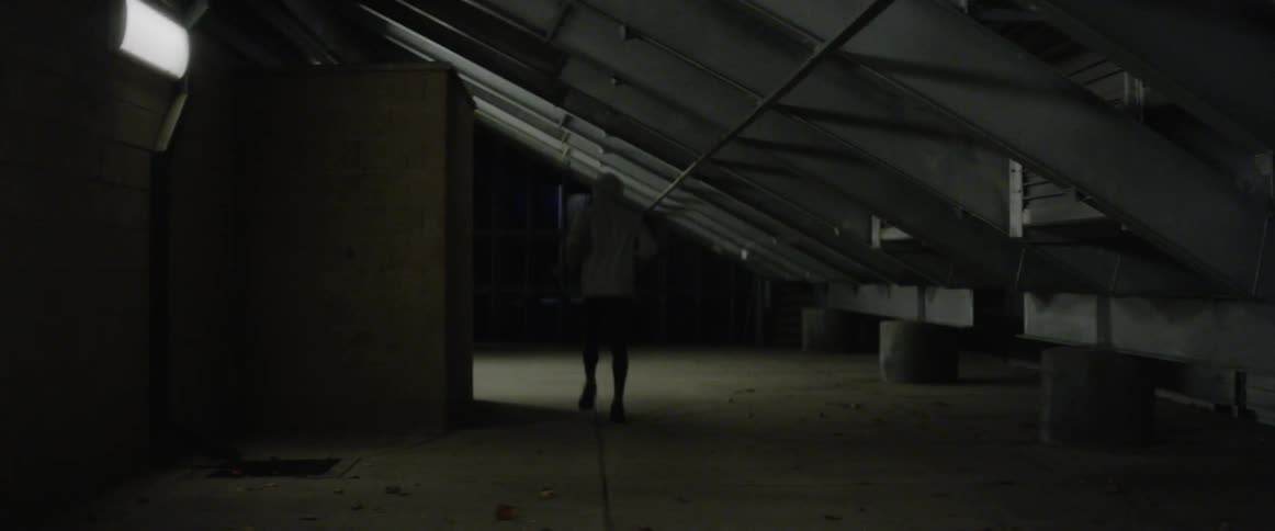 A man is stretching his legs out running down the hall