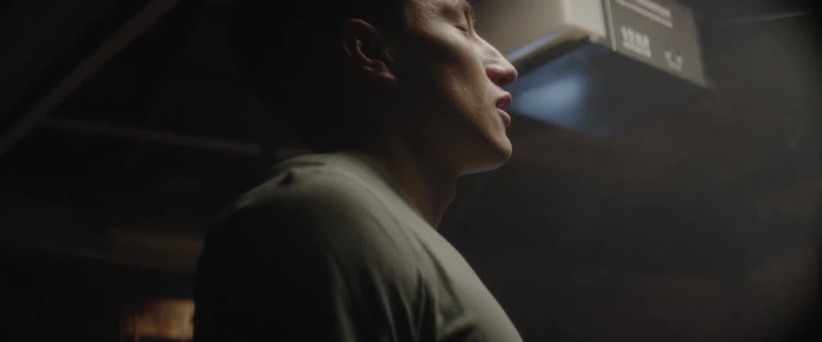 Man exhales in a cold room with visible breath