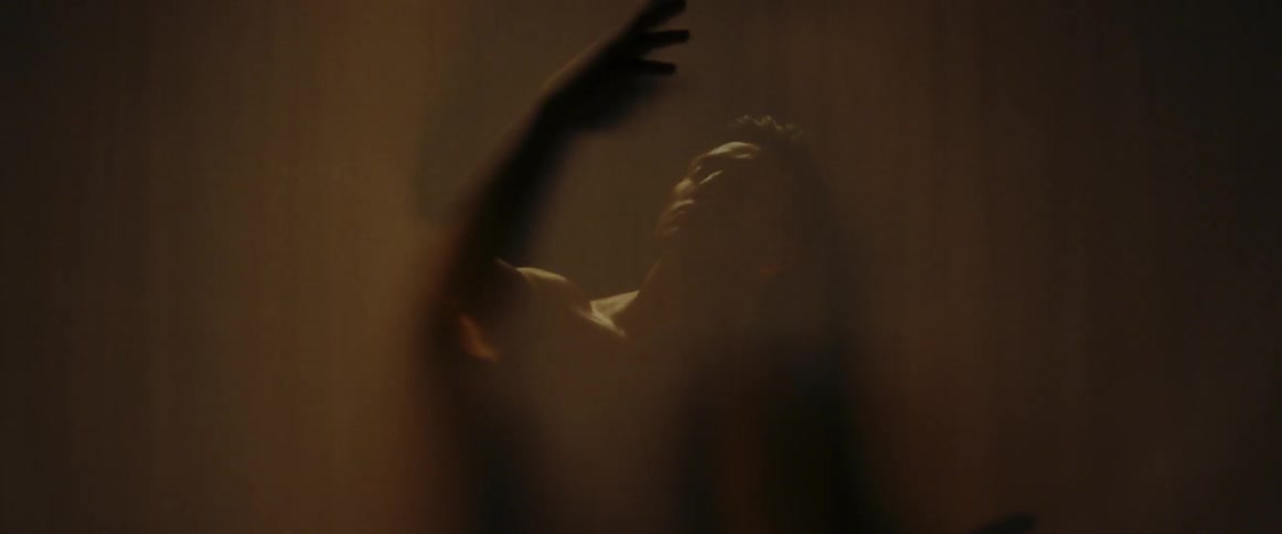 A man reaches around in the dark