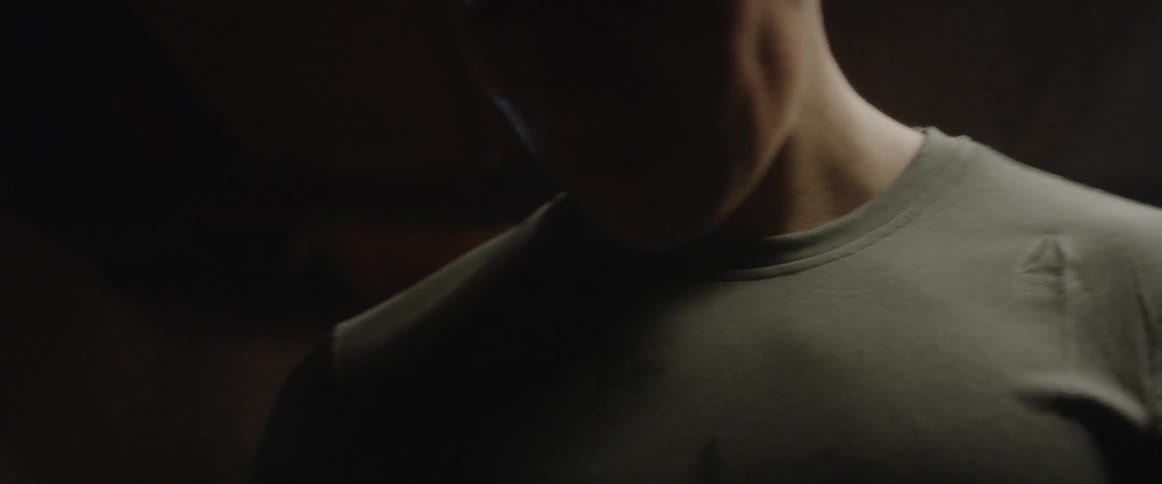 A man drinks water from a bottle after a workout