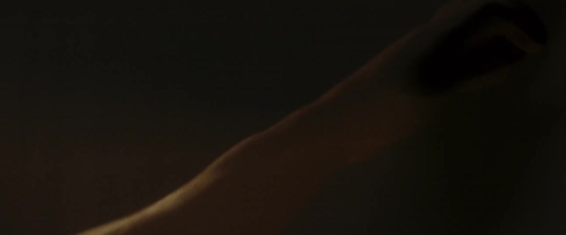A hand is slowly swaying around in the dark